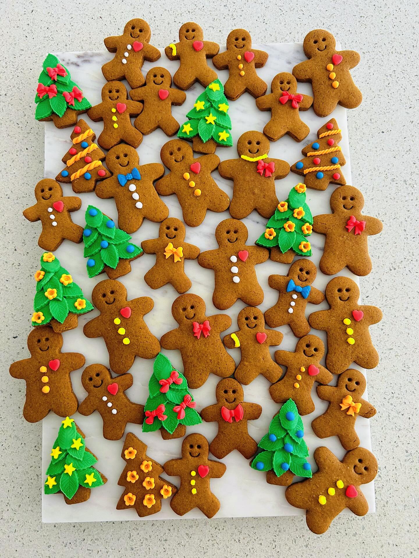 A tray of hand-decorated gingerbread men and trees