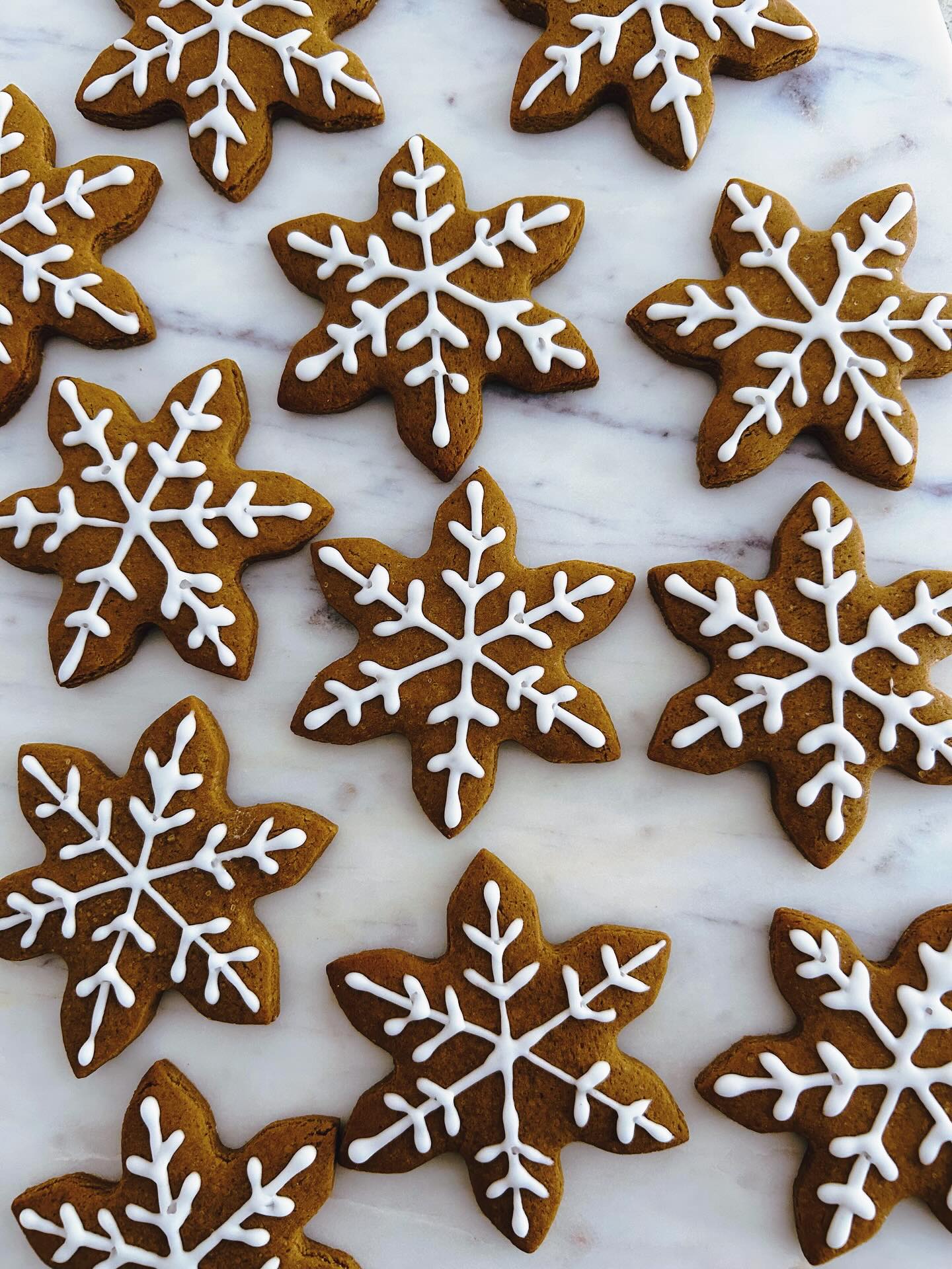 Gingerbread snowflakes piped with white royal icing